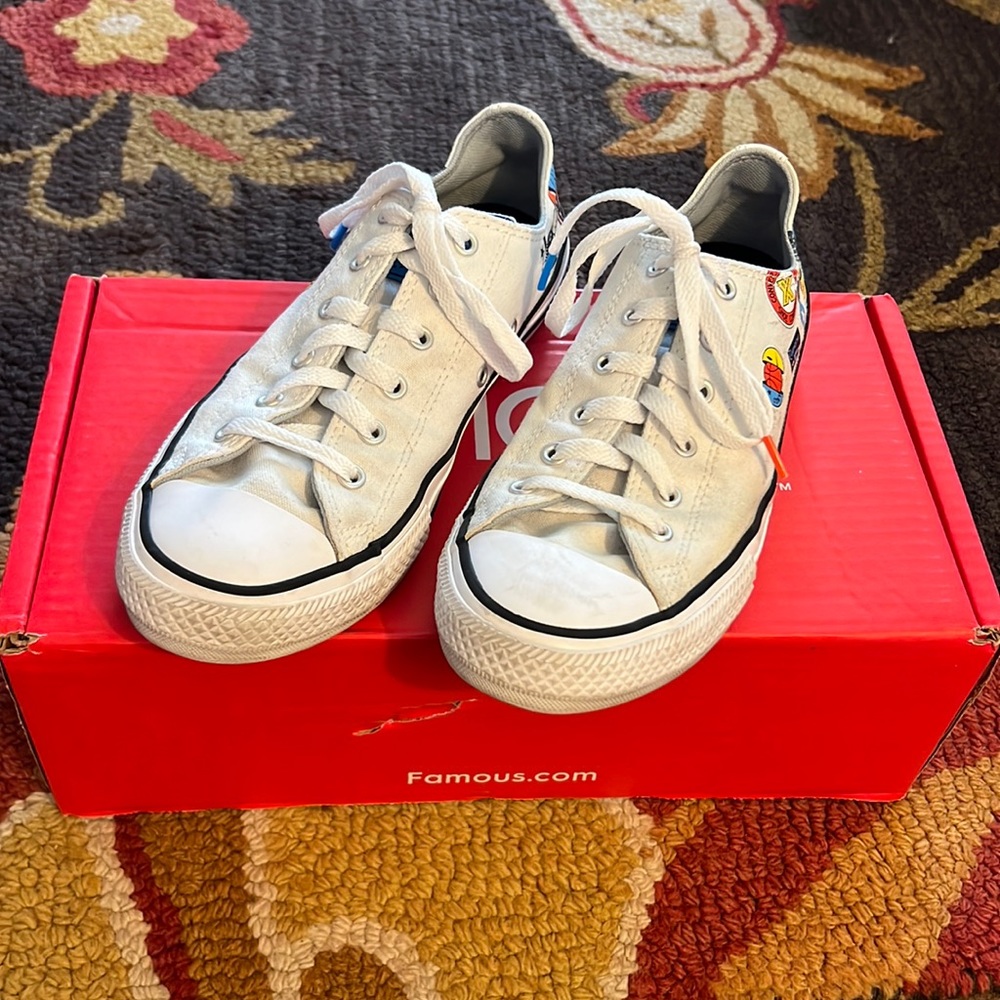Famous Footwear White Low Top Converse With Design On Heels.